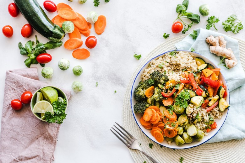 An example of a balanced diet with a salad, vegetables, and fruit 