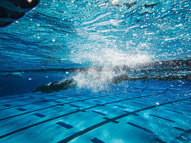 A person dives into a pool as they work to improve their fitness