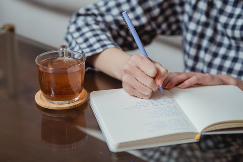 A person writes in a journal 