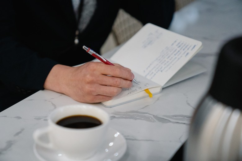 a person writing to experience how journaling benefits mental health