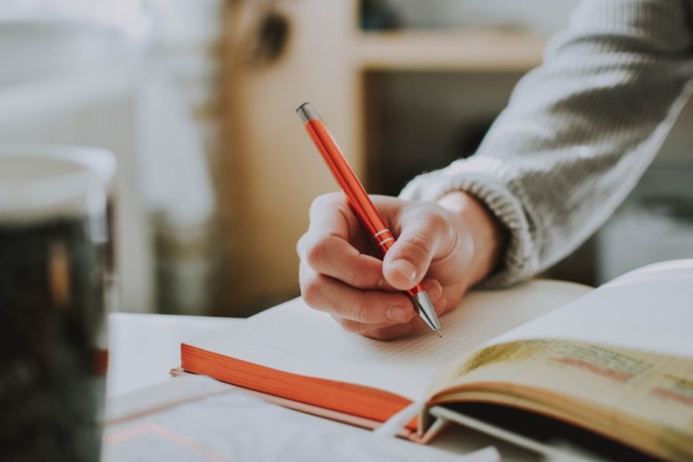 A person begins a new journal entry