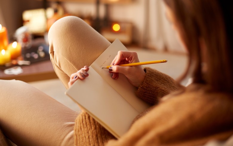 a person journaling negative thoughts