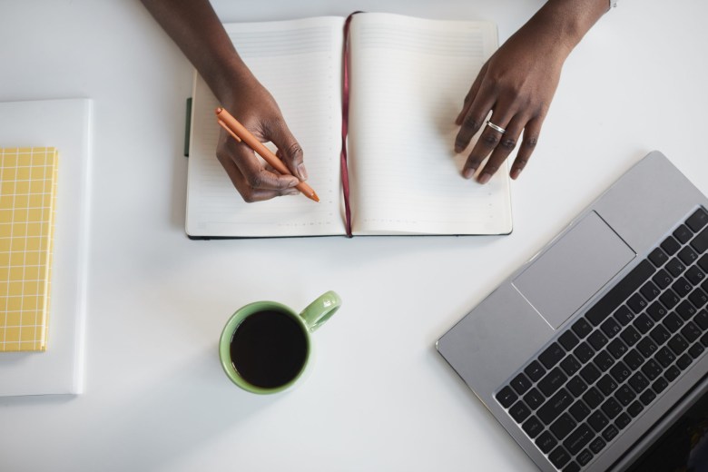 A person uses journaling to explore limiting beliefs