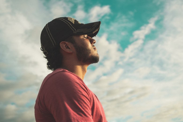 A person practices mindfulness by closing their eyes and tuning into the moment
