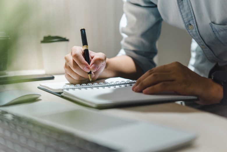 A person uses journaling to explore perfectionism 