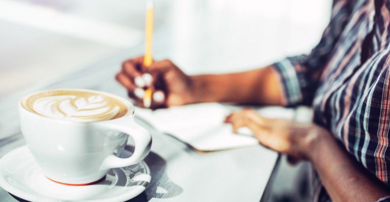 a sene of journaling with a notebook and latte.
