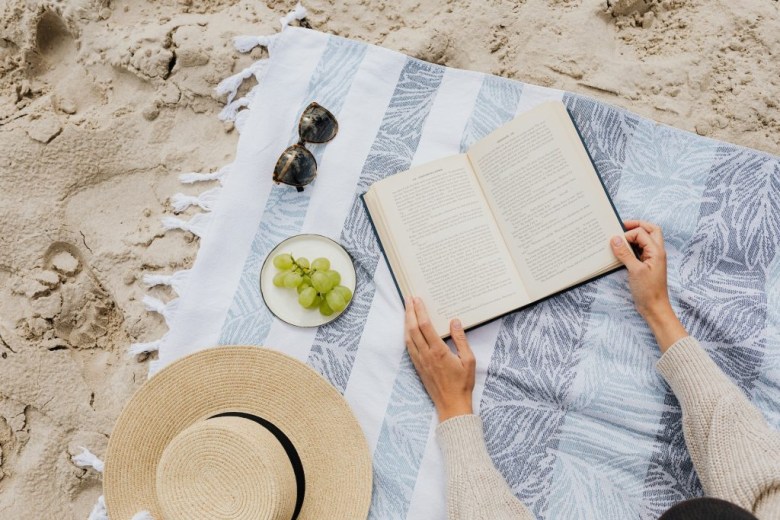 a person relaxes at the beach as a form of self-care