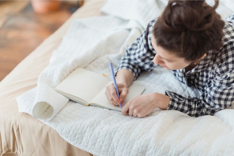 A person writes in their therapy journal