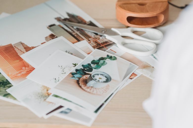 A person creates a vision board with photos 