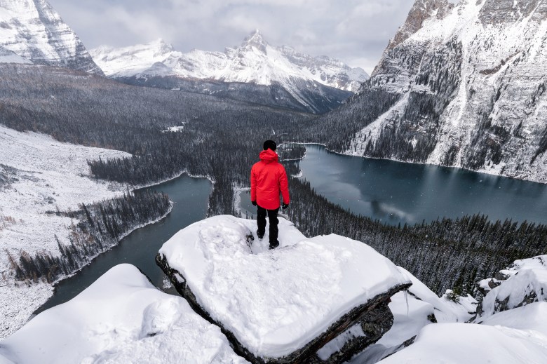 A person stands on a ridge as a metaphor for limiting beliefs