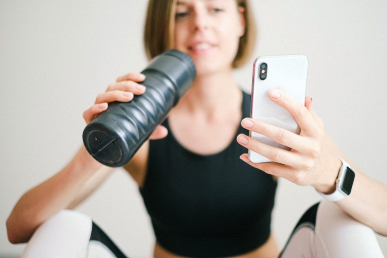 A person looks at their fitness journal after a workout